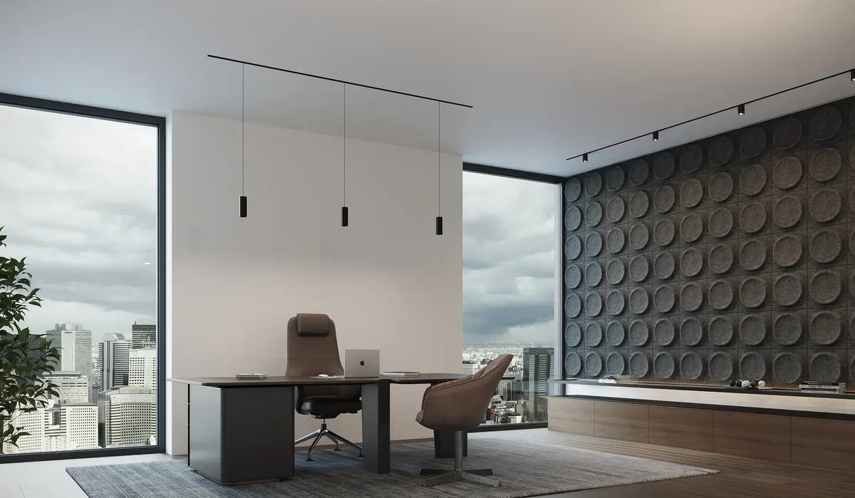 Executive office with slim StencilFlex surface rails carrying cylinder pendants over a desk and spotlights washing a felt acoustic wall