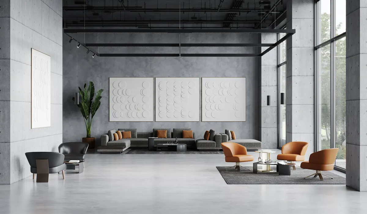 Concrete-walled lounge with a suspended rectangular StencilFlex framework carrying track spotlights above grey sofas and tan leather chairs