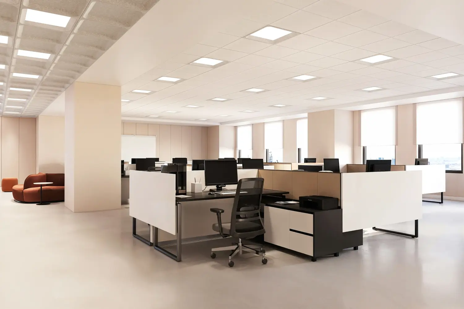 Tacet acoustic ceiling light panels illuminating an open-plan office of white-partition workstations, with an orange lounge area beyond